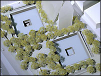 An architectural model seen from above: two square sunken pools set in a plaza densely planted with trees
